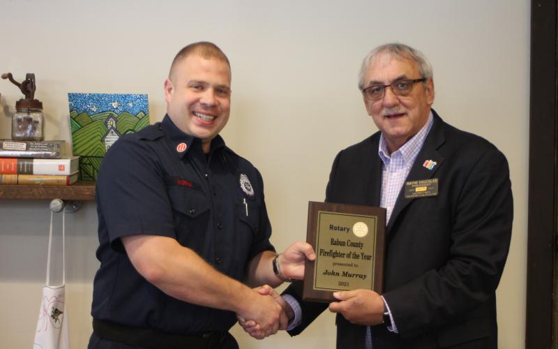 Megan Broome/The Clayton Tribune. John Murray with Rabun County Fire Services, left, is presented with the 2021 Rotary Club of Clayton Firefighter of the Year award by Rotary President Wayne Knuckles at the club’s meeting held at the Food Bank of Northeast Georgia Teaching Kitchen last Thursday.