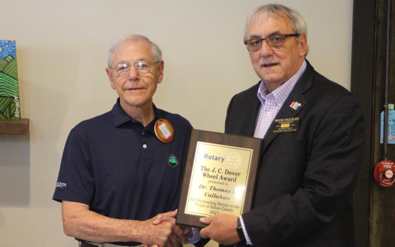 Megan Broome/The Clayton Tribune. Dr. Tom Callahan, left, is presented with the 2021 Rotary Club of Clayton  J.C. Dover Wheel Award by Rotary President Wayne Knuckles at the club’s meeting held at the Food Bank of Northeast Georgia Teaching Kitchen last Thursday.