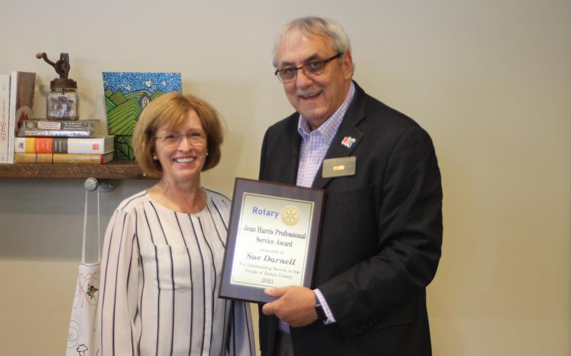 Megan Broome/The Clayton Tribune. Sue Darnell, left, is presented with the 2021 Rotary Club of Clayton Jean Harris Professional Award by Rotary President Wayne Knuckles at the club’s meeting held at the Food Bank of Northeast Georgia Teaching Kitchen last Thursday.