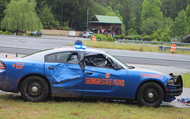 Megan Broome/The Clayton Tribune. A Georgia State Patrol vehicle was struck by a vehicle that first struck an embankment following a maneuver by GSP to stop a suspect after he fled from a traffic stop on Ga. 15 near Lofty Branch Rd. in Rabun County Monday morning. The suspect was pursued by GSP before crashing his vehicle and fleeing the scene on foot.