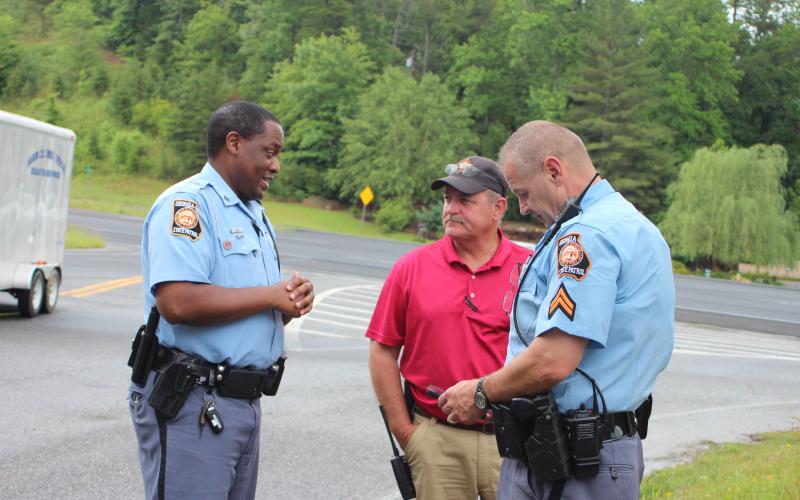 Megan Broome/The Clayton Tribune. Georgia State Patrol and the Rabun County Sheriff’s Office were responding agencies to a scene near the Tallulah River Monday where a suspect fled on foot following a traffic stop by GSP earlier that morning. Trooper Vance Henry, Jr. Georgia State Patrol Post 7 Toccoa, left, Marty Talley, Rabun County Sheriff’s Office Chief Investigator, and Corporal John Getty, Georgia State Patrol Post 7 Toccoa, discuss details of the incident at the scene.