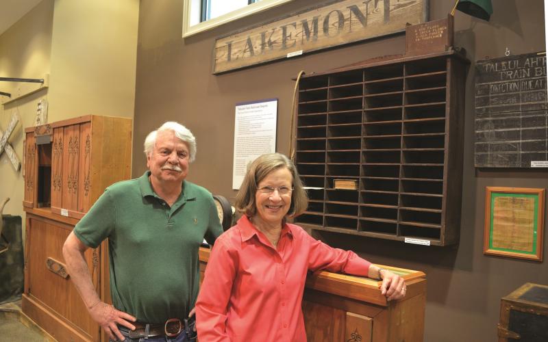 Wayne Knuckles/The Clayton Tribune. Volunteers Dick Cinquina, left, and Linda Bardin show some of the exhibits to be featured when the Rabun County Historical Society reopens Friday, June 11.