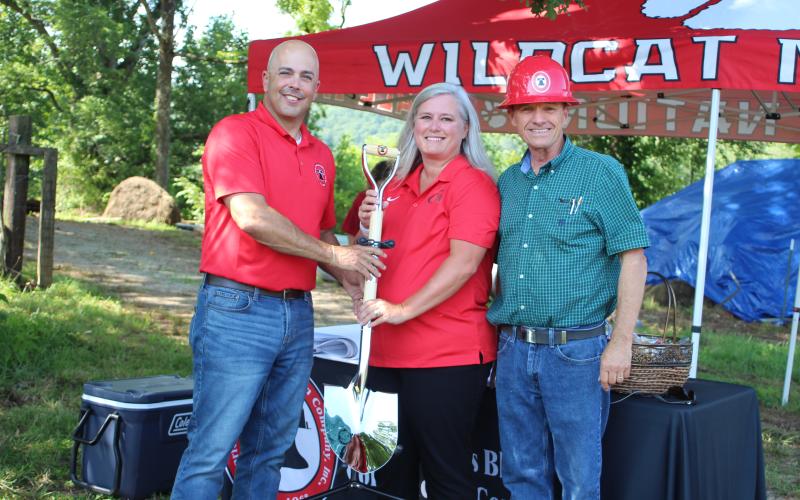 Megan Broome/The Clayton Tribune. Rod Nix from Charles Black Construction, left, hands Rabun County Schools Superintendent April Childers and BOE Chairman Steve Cabe the groundbreaking shovel at the event last Thursday. It marked the start of construction for the RCHS $7 million Agricenter. Charles Black Construction won the bid for the project. The 31 acres of land will be the future home of the Rabun County Future Farmers of America (FFA).