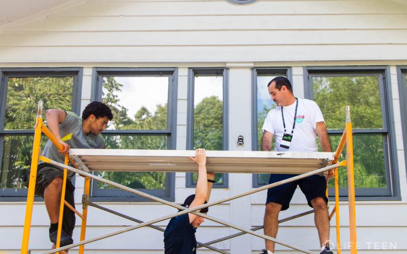Submitted photo. The St. Columbia Parish paints Victory Home, a faith-based drug and alcohol rehabilitation program, last week for Restore Mission Week as part of the Life Teen Movement at Camp Covecrest.