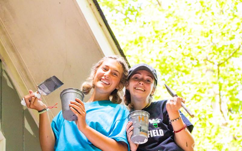 Submitted photo. Youth members of St. Ann’s Parish in Marietta, Ga. paint a home as a project for the Restore Mission Week with the Life Teen movement at Camp Covecrest recently..