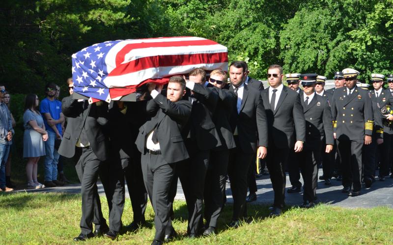 Wayne Knuckles/The Clayton Tribune. The body of Chandler Breck Patterson was brought to Betty's Creek Baptist Church last Friday for a Fireman's Farewell, which included the ringing of a fire bell and the "last call" over the radio.