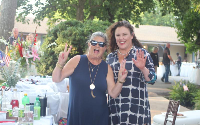 Megan Broome/The Clayton Tribune. Lisa Edwards and Natalie Dillard have fun and share a laugh at the Fourth of July festivities at The Dillard House over the weekend.