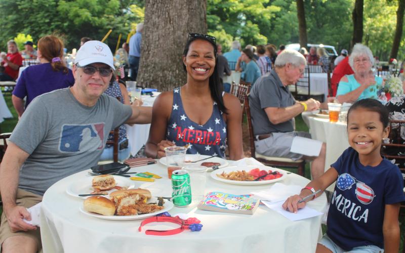 Megan Broome/The Clayton Tribune. Megan Broome/The Clayton Tribune. Mark Aguilar, Contessa Aguilar and Alise Aguilar sport their red, white and blue and enjoy the Fourth of July festivities at The Dillard House on Sunday.
