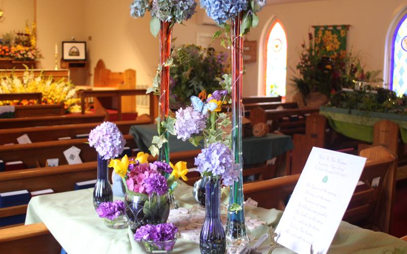 Megan Broome/The Clayton Tribune. Floral arrangements at St. James Episcopal Church were created to represent the theme of “God’s Creation: Behold, I make all things new” for the church’s 14th annual Flower Festival on Saturday. Floral arrangements like this were designed to represent “God’s creations.”