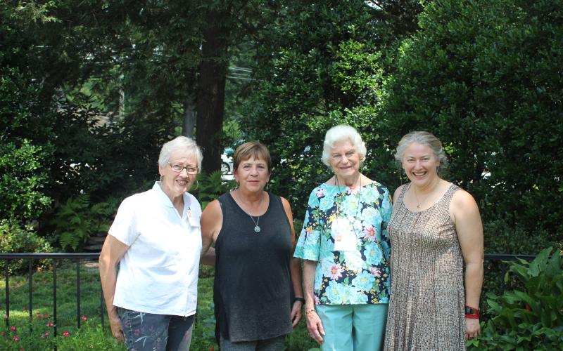 Megan Broome/The Clayton Tribune. Kathy Booker, left, Charle Statler, Jan Bomar and Stacie Booker stand in front of the gardens at St. James Episcopal Church during the 14th annual Festival of Flowers event on Saturday. The theme was “God’s Creation: Behold, I make all things new” and floral arrangements were created to represent and celebrate God’s creations.