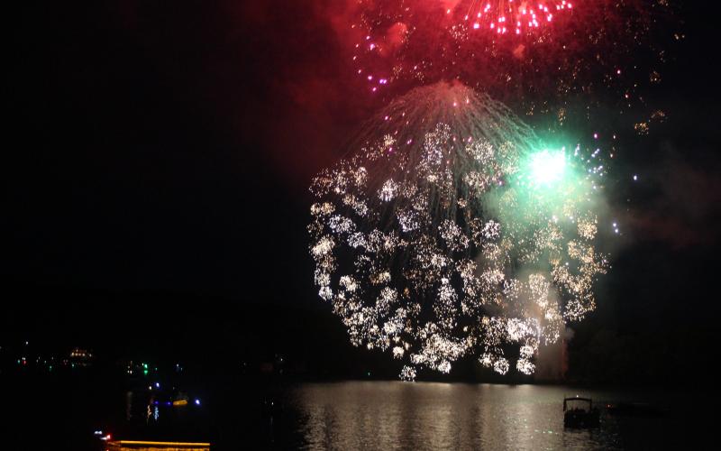 Megan Broome/The Clayton Tribune. Megan Broome/The Clayton Tribune Fireworks light up the night sky and reflect in the water at Lake Burton as hundreds of boats flock to view the annual fireworks on Saturday to celebrate Independence Day.