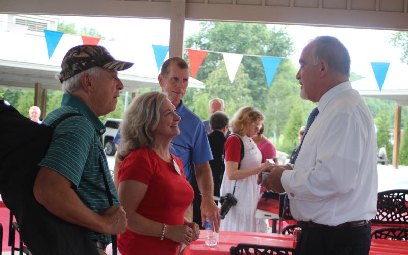 Megan Broome/The Clayton Tribune. Jim Cope, left, and Kim Gurtler converse with Georgia State School Superintendent Richard Woods at a BBQ event hosted by the Rabun County Republican Party Monday. Woods was one of the guest speakers and is running for reelection in 2022.