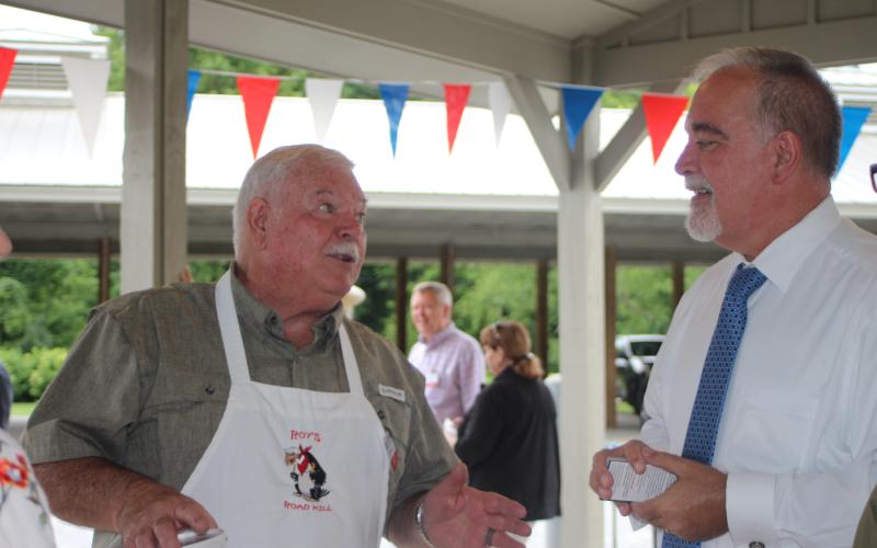 Megan Broome/The Clayton Tribune. Roy DeCoach converses with Georgia State School Superintendent Richard Woods at a BBQ event hosted by the Rabun County Republican Party Monday. Woods was one of the guest speakers and is running for reelection in 2022.