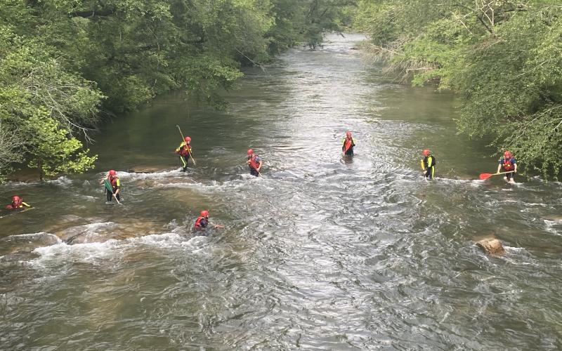 Submitted photo. The Rabun County Search and Rescue swiftwater rescue team trek through the Tallulah River to locate a drowning victim in June. Rescuers say that speciality training they received in Texas gave them the skills they needed to navigate through the strong current  and locate a missing person on the Tallulah River in June.