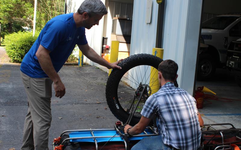 Megan Broome/The Clayton Tribune. Rabun County Search and Rescue Lt. Chris Wright, left, and Chief Will McCracken demonstrate how a Stokes Basket is used to transport patients through various types of terrain when they are rescued.