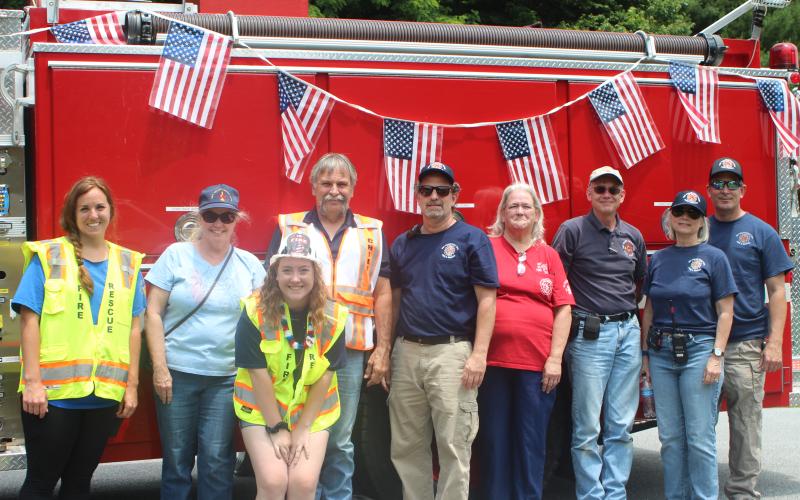 Megan Broome/The Clayton Tribune. The Sky Valley/Scaly Mountain Fire Department held a cookout as part of Fourth of July festivities on Saturday. From left Tonya Anderson, Jenny Bowman, Sally Holt, Fire Chief Tommy James, Dennis Bowman, Kay Shurban, Mark Gramlich, Beth Fierberg and Dave DaCastello.