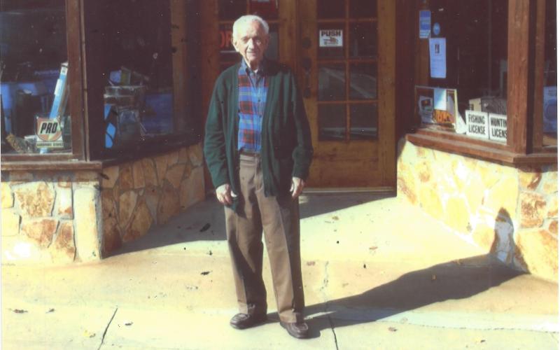 Photo courtesy of Rabun County Historical Society. Charlie Mac Dickerson stands in front of the Dickerson Hardware Building. He established the hardware company in 1948. A memorial park is located behind the hardware building to honor his memory.