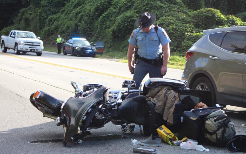 Megan Broome/The Clayton Tribune. A Florida couple was injured following a motorcycle accident at Highway 441 and Cross St. in Mountain City Sept. 2. Georgia State Trooper Brady Galloway works the accident scene.