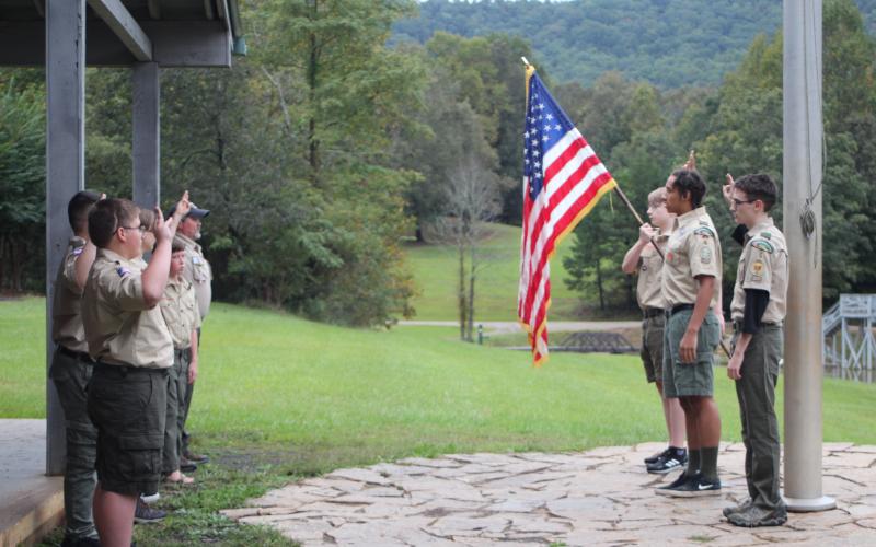 Megan Broome/The Clayton Tribune. Boy Scout Troop 6 starts a meeting at Camp Rainey Mountain in Clayton with the Pledge of Allegiance and the Scout Oath.