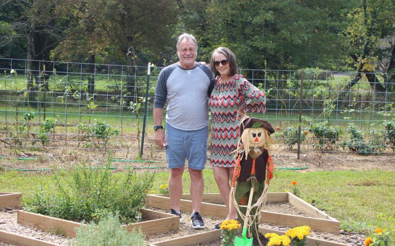 Megan Broome/The Clayton Tribune. Mark and Michelle Edwards tour the Old School Garden during its annual plant sale last Saturday.