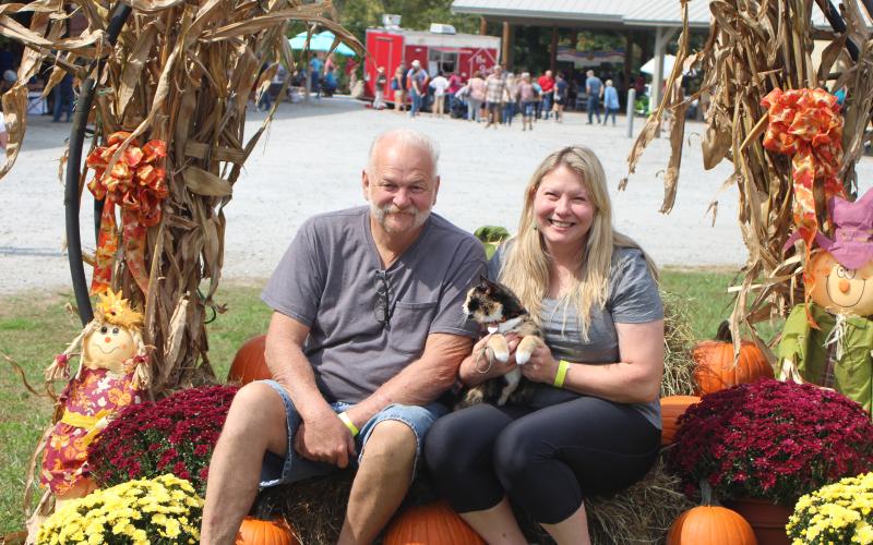 Megan Broome/The Clayton Tribune. Rusty Brown, left, Amy Brooks and their cat named Bonus attend the Foxfire Mountaineer Festival last Saturday.