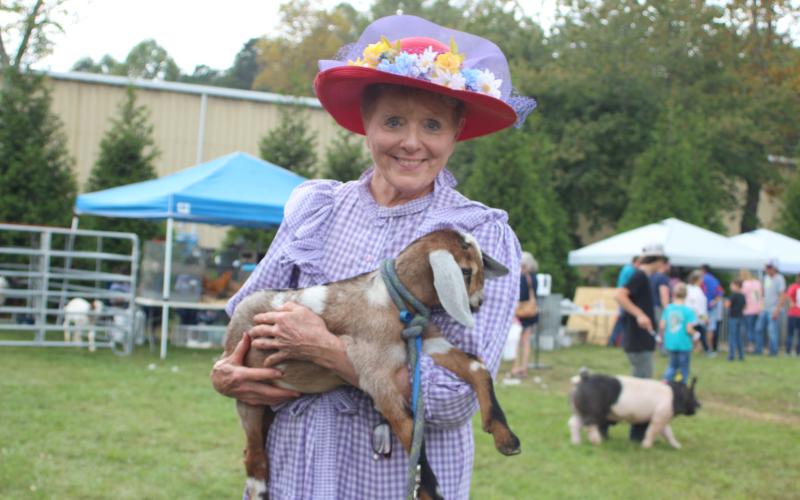 Megan Broome/The Clayton Tribune. Marywinn Lent is with a 5-week-old goat named spot at the Foxfire Mountaineer Festival last Saturday.