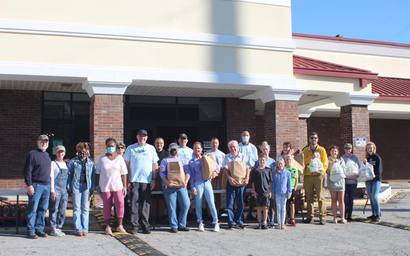 Megan Broome/The Clayton Tribune. Law enforcement officers, volunteers from Fight Abuse in the Home (FAITH) and local churches participated in the Faith and Blue event last Saturday at the Food Bank of Northeast Georgia.