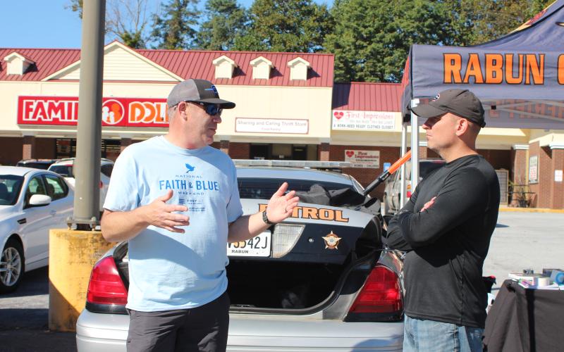 Megan Broome/The Clayton Tribune. Rabun County Sheriff Chad Nichols, left, and John Hutcheson, pastor of Tabernacle Baptist Church and chaplain for the sheriff's office, participate in the Faith and Blue event last Saturday.