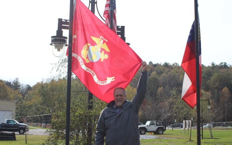 Megan Broome/The Clayton Tribune. John Bradshaw proudly holds a United States Marine Corps flag.