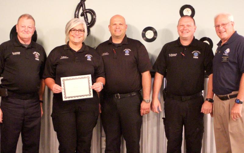 Megan Broome/The Clayton Tribune. Lieutenant Tammy Jones (second from left) is presented with the Rotary Club of Clayton EMS Person of the Year Award at an Oct. 28 Rotary meeting. Also pictured are Mike Carnes, EMS/911 director; Lieutenant Brain Panell (center); Captain Trampes Stancil; and Jef Fincher, Rotary Club of Clayton president.