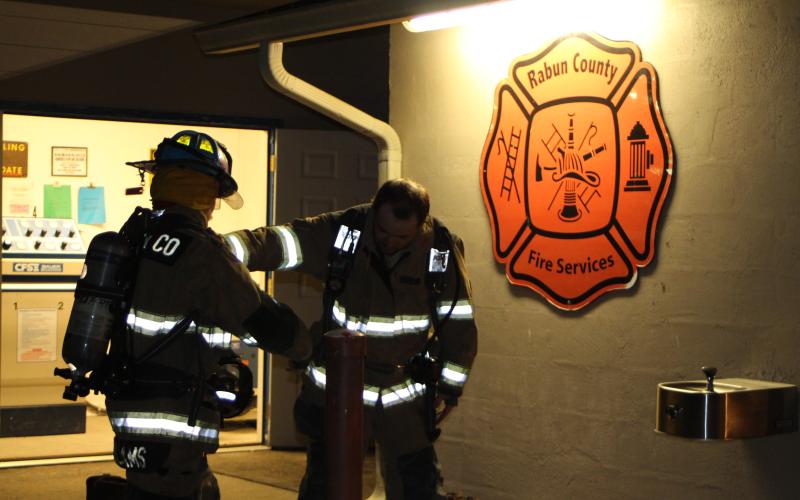 Megan Broome/The Clayton Tribune. Firefighters Isaac Williams and Jess Watts prepare for live fire training.