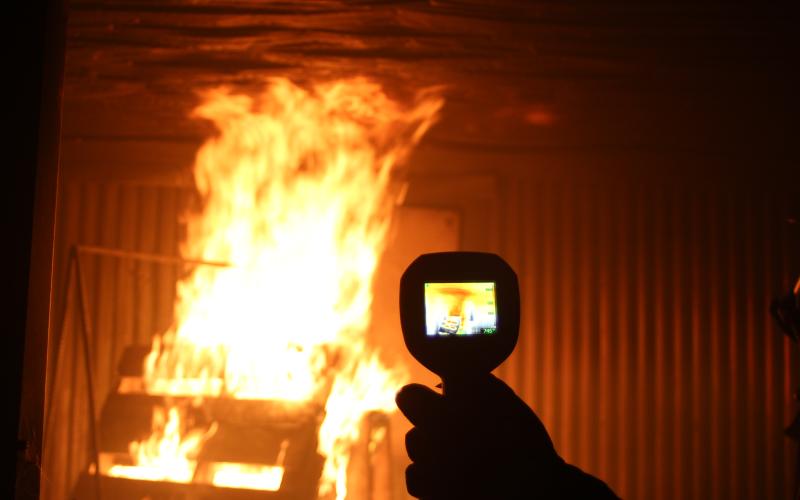 Megan Broome/The Clayton Tribune. Firefighter Michael Mazarky holds a Thermal Imaging Camera. It displays how hot the fire is burning. Firefighters use these as they assess the fire and rescue victims inside a structure. The darker colors on the screen represent cooler areas and the colors get lighter as temperature increases.