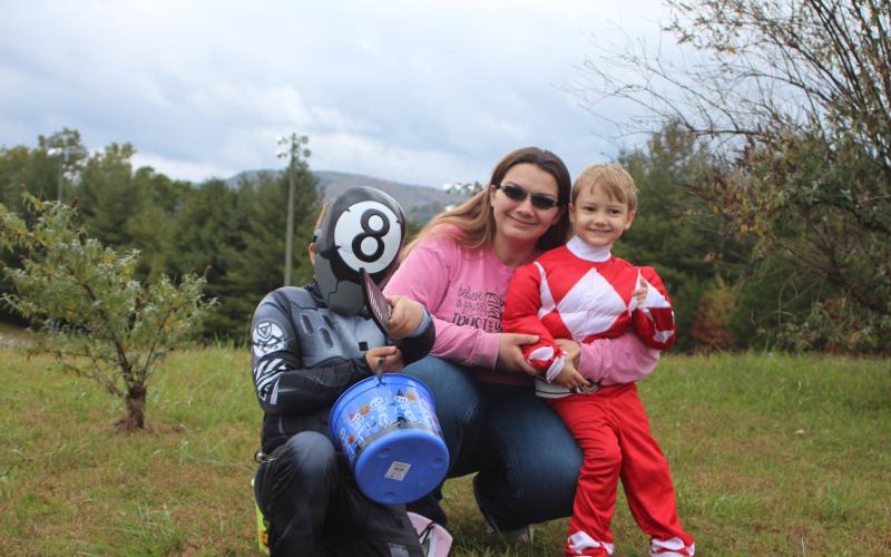 Megan Broome/The Clayton Tribune. Mason English, left, Megan English, and Jackson English go Trick or Treating.