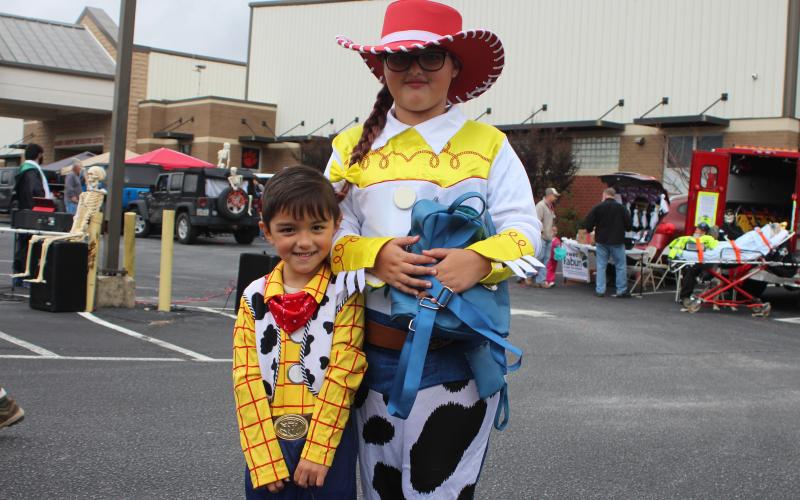 Megan Broome/The Clayton Tribune. Bjorn Guzman, 4, left, and Illianna Guzman, 9, dress up as characters from Toy Story for the Trunk or Treat.