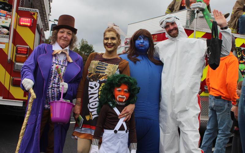 Megan Broome/The Clayton Tribune. Debbie Turpin, left, Carrie Hackett, Amanda Hackett, Jon Turpin and Jasper Turpin, 5, (front), dress up as characters from Willy Wonka and the Chocolate Factory at the Recreation Department’s Trunk or Treat last Saturday.