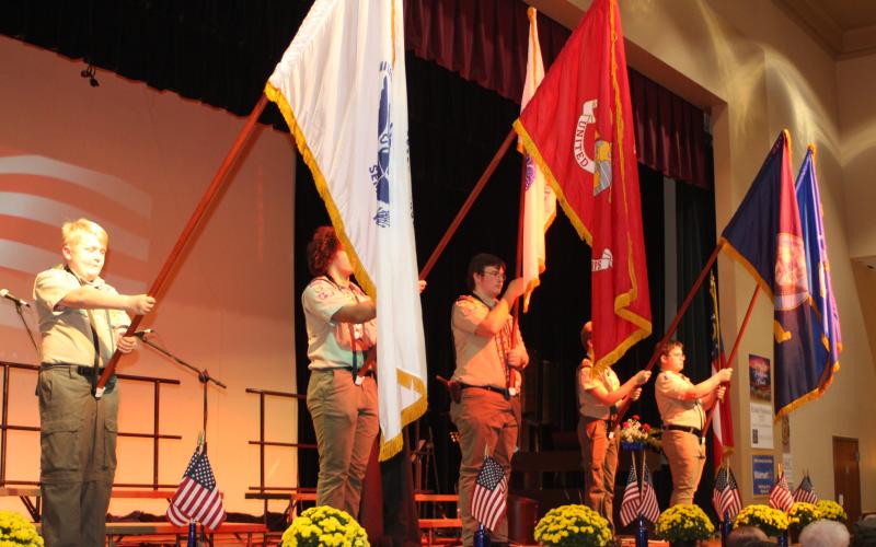 Megan Broome/The Clayton Tribune. Samuel Cochran, Boy Scout Troop 6, left, Ben McKissack, Boy Scout Troop 19, Liam Broz, Boy Scout Troop 19, Emmit Watts, Boy Scout Troop 19, and Andy Leff, Boy Scout Troop 16, present flags to honor each branch of the military at the Veterans Appreciation Dinner Nov. 11.