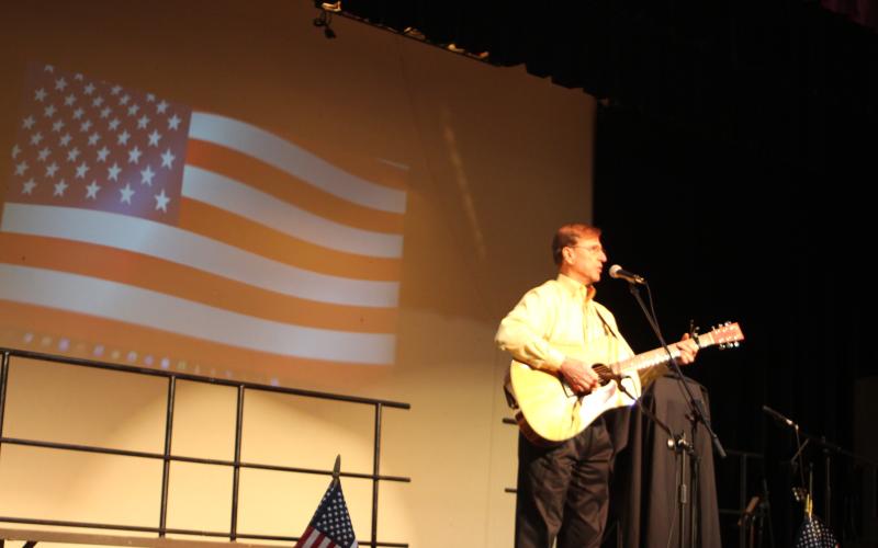 Megan Broome/The Clayton Tribune. Greg Funkhouser performs his original song “Thank you for Answering the Call” at the Veterans Appreciation Dinner Nov. 11.