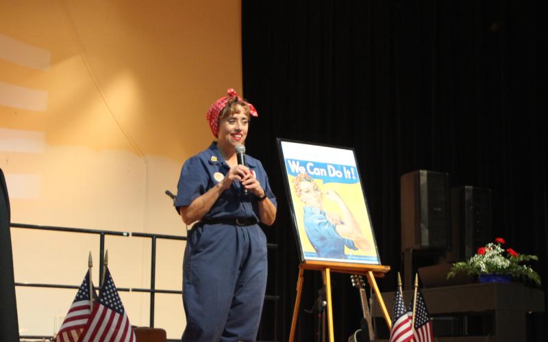Megan Broome/The Clayton Tribune. Storyteller Carol Cain gave a tribute to Rosie the Riveter through an animated presentation of stories about the women from WWII who worked at the home front while soldiers went to war.