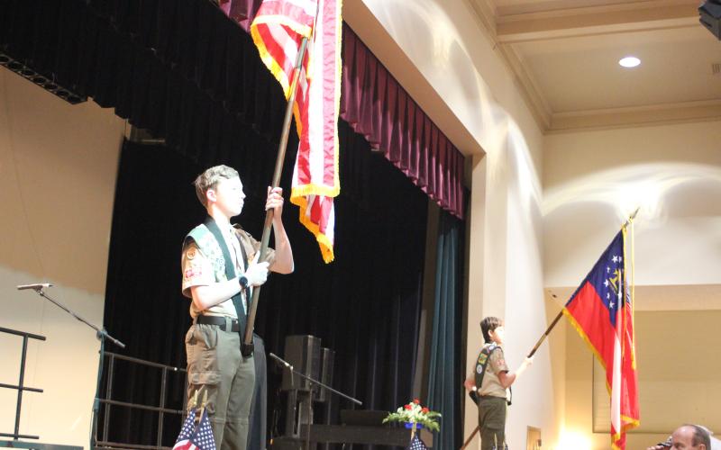 Megan Broome/The Clayton Tribune. Quinn Weingartz, left, and Chauncey Nalley from Boy Scout Troop 19 present the colors at the Veterans Appreciation Dinner Nov. 11.