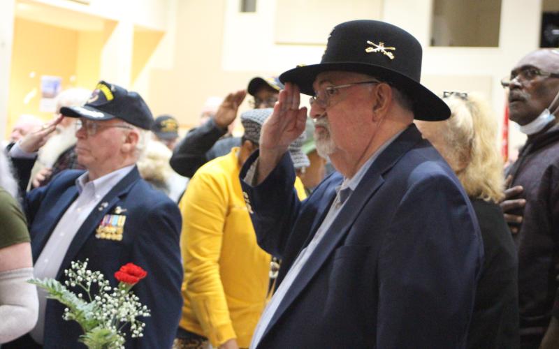 Megan Broome/The Clayton Tribune. Ray Kreiner, Army and 30-year Veteran, salutes to honor fellow soldiers at the Veterans Appreciation Dinner Nov. 11.