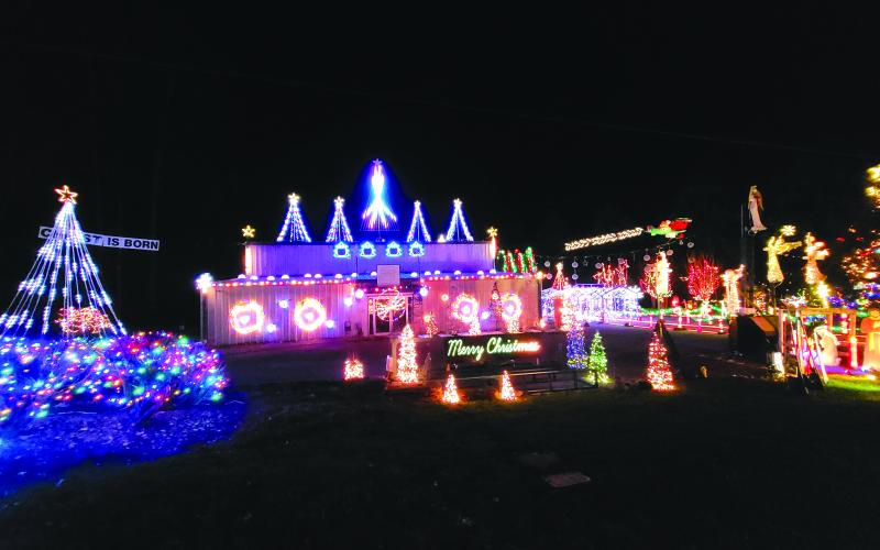 Megan Broome/The Clayton Tribune. Visitors to the Christmas Village of Lights travel the path outlined with candy canes to visit Santa and Mrs. Claus and the miniature village display located indoors. Visitors can also take part in a scavenger hunt through the village sets. The event is sponsored by FAITH.