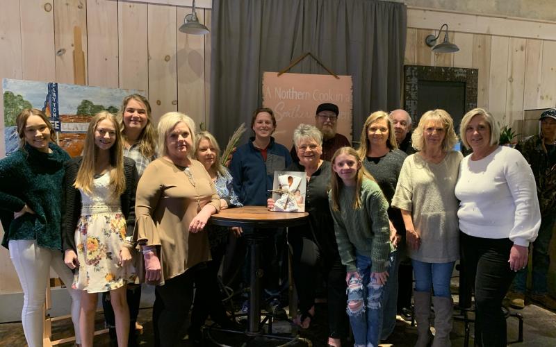 Photo courtesy of Teka Earnhardt. Several Clayton Cafe employees and community members attended the cookbook signing event on Sunday. Pictured are Cheyenne Dulucai, Chyanne Vinson, Bella Andrews, Valerie Haggerty, Lisa Shilling, Seth Curtis, Bonnie Edmonds, owner, Will Curtis, Carleigh Rae Sturm, Amy Watts, Gary Sossebee, Ranee’ Thomas, and Monica Fortson. Bonnie Edmonds and Tom Edwards are the authors of the cookbook “A Northern Cook in a Southern Kitchen."