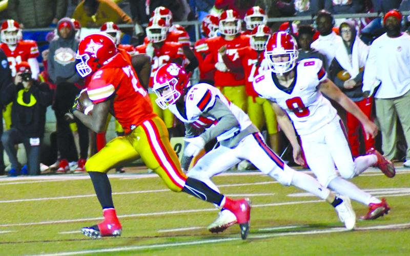 Enoch Autry/The Clayton Tribune. Rabun County defenders Will Turpin and Cory Keller try to track down Thomasville running back Malik Harper. The Bulldogs advanced to the Class AA semifinals against Callaway.