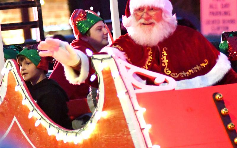 Enoch Autry. Santa waves to all the nice Rabun County children as his lit sleigh rolls down Main Street.