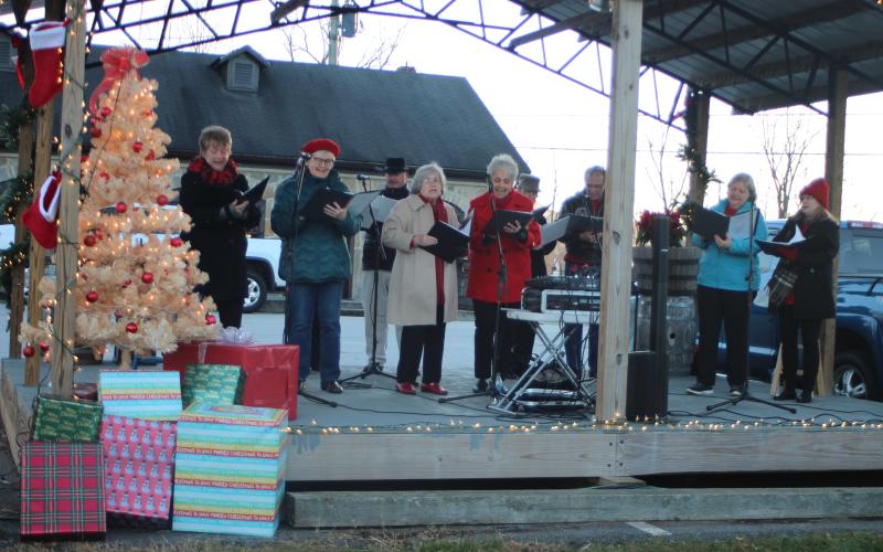 Megan Broome/The Clayton Tribune. Linda Beal and Friends sings Christmas carols for the “A Night Out in Christmastown” event held in Dillard Dec. 8.