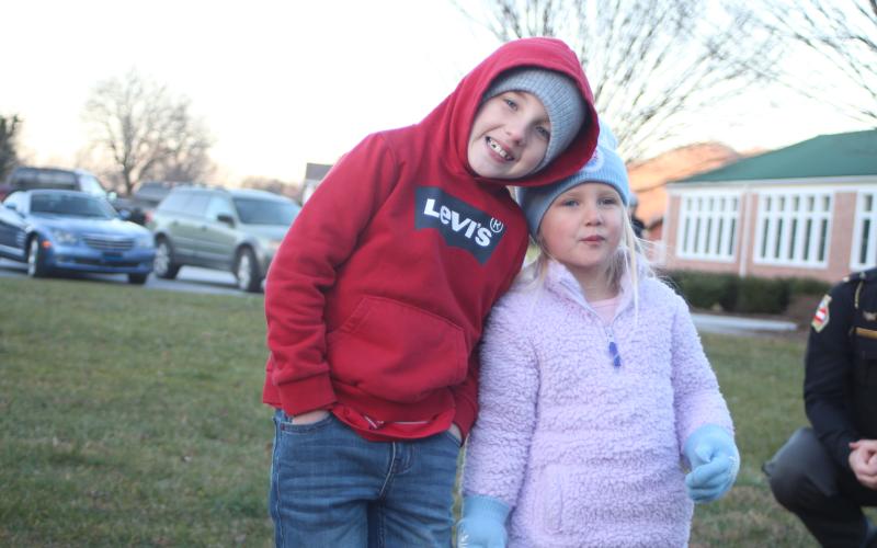 Megan Broome/The Clayton Tribune. Chasten Roberts, 7, left, and Raelynn Roberts, 4, enjoy the Christmas lights and fun and games at the  “A Night Out in Christmastown” event held in Dillard Dec. 8.