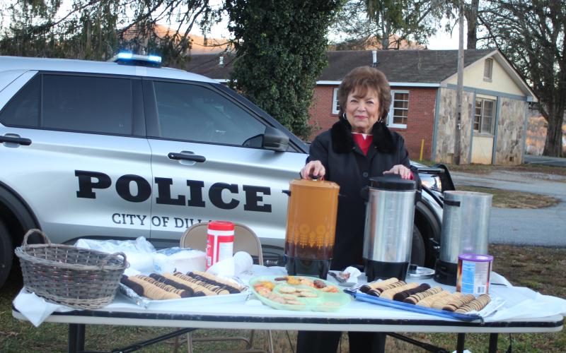 Megan Broome/The Clayton Tribune. Dillard City Council Member Carron Grist spreads Christmas cheer by passing out hot chocolate and refreshments at the  “A Night Out in Christmastown” event held in Dillard Dec. 8.