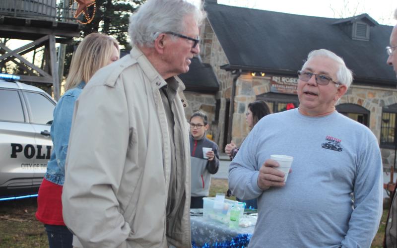 Megan Broome/The Clayton Tribune. Dillard City Mayor Bill Robinson, left, talks with Andy Sudderth at the  “A Night Out in Christmastown” event held in Dillard Dec. 8.