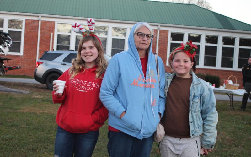 Megan Broome/The Clayton Tribune. Neva Dills, 13, left, Vickie Tallent, and Hannah Tallent, 10, enjoy Christmas lights and fun and games at the  “A Night Out in Christmastown” event held in Dillard Dec. 8.