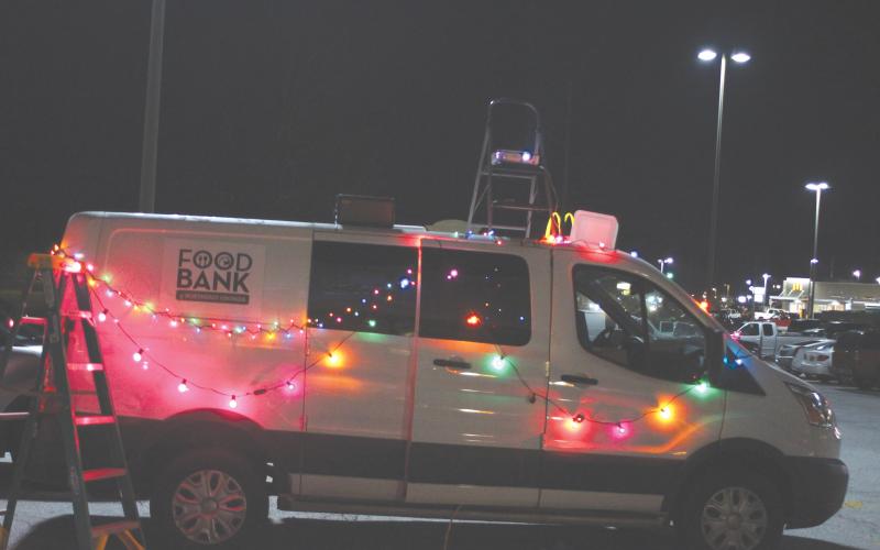 Megan Broome/The Clayton Tribune. The Food Bank of Northeast Georgia Transport van was decorated in colorful Christmas lights for the Christmas toy drive held at the Food Bank of Northeast Georgia last Friday.